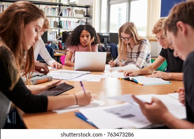 Group Of College Students Working Around Table In Library - Powered by Shutterstock