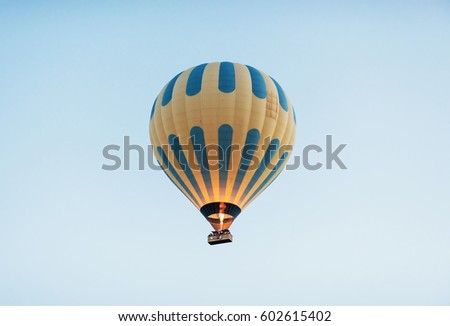 A group of colorful hot air balloons against a blue sky.