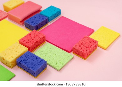 Group of colorful polyurethane dish sponges and other cleaning stuff isolated on pastel pink background - Powered by Shutterstock