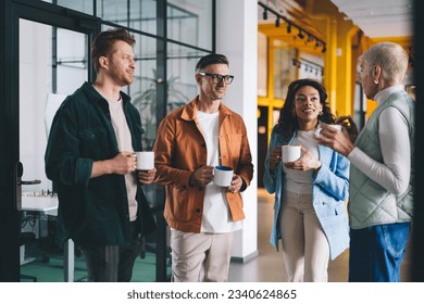 Group of competitive male and female partners in smart casual clothes spending working time for analyzing business strategy and discuss office marketing during coffee break, teamwork collaboration - Powered by Shutterstock