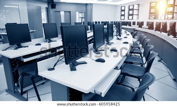Group of\
computer neatly placed in a computer\
lab.