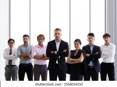 Group Of Confident Business People In Various Diversity With Arms Crossed In Corporate Office Setting - Diverse Races, Genders, Age.