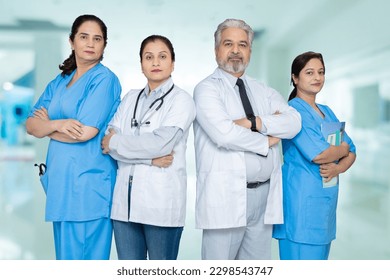 Group of confident indian male and female doctors and nursing staff with stethoscope standing cross arms looking at camera, healthcare concept.