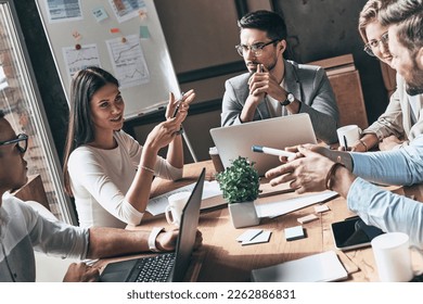 Group of confident young people discussing business while having meeting in the office - Shutterstock ID 2262886831