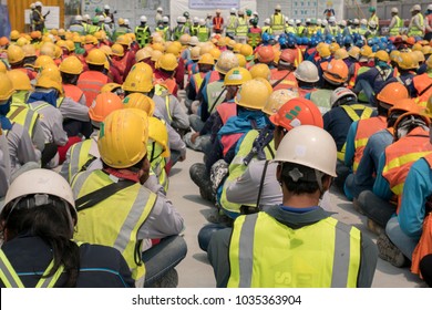 Group Of Construction Worker Helmet And Safety Uniform Meeting On Morning Talk Before Work At Warehouse Under Construction Site