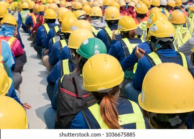 Group Of Construction Worker Helmet And Safety Uniform Meeting On Morning Talk Before Work At Warehouse Under Construction Site