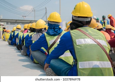 Group Of Construction Worker Helmet And Safety Uniform Meeting On Morning Talk Before Work At Warehouse Under Construction Site