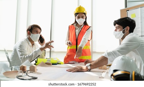 Group Construction Worker Are Meeting And Brainstorm Together At The Workplace To Discuss For New Project During Covid19 Pandemic, Architect Engineer Teamwork Wearing Face Mask While Discuss Together.