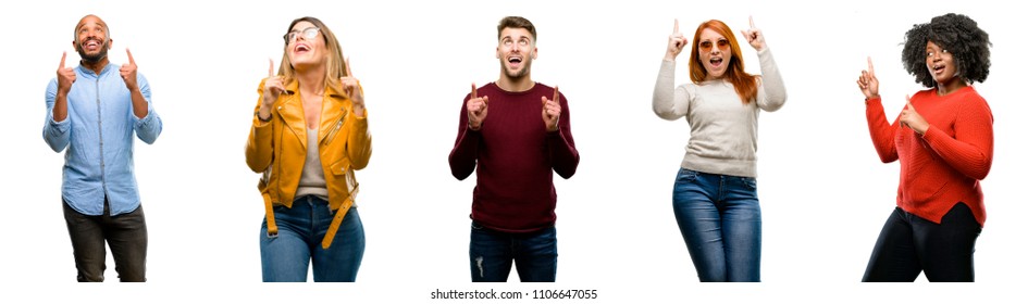 Group of cool people, woman and man happy and surprised cheering expressing wow gesture pointing up - Shutterstock ID 1106647055