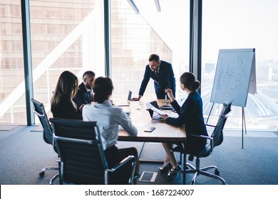 Group of coworkers in formal wear sitting at table in conference room and arguing about project of company development during meeting - Shutterstock ID 1687224007