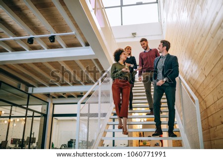 Group of coworkers going down the stairs