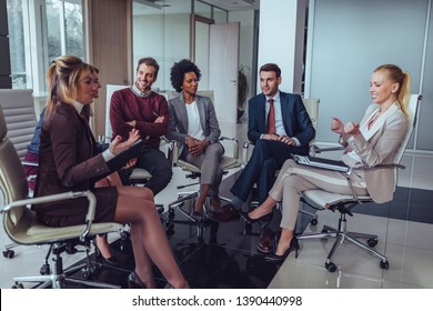 Group of coworkers having meeting and discussing about business goals - Shutterstock ID 1390440998
