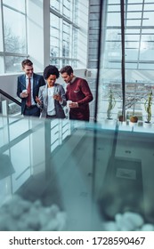 Group Of Coworkers Using Technology At Office Break