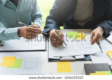 Group of creative designer in mobile application design, analysis and planning development app in the office.