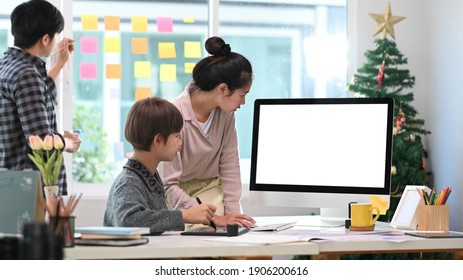 Group of creative designer using digital tablet and discussing business strategy at office.