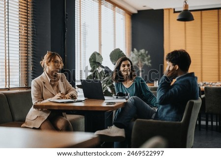 A group of creative professionals collaboratively discussing ideas in a casual office meeting setup.