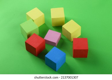 Group of cubes with multicolour. Pink cube surrounded big cubes