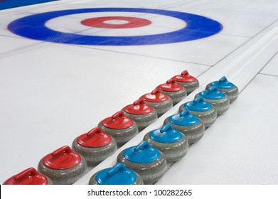 Group Of Curling Rocks On Ice