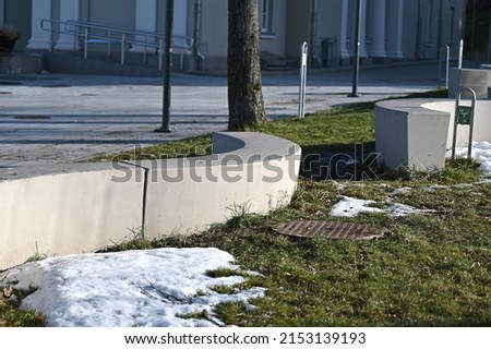 a group of curved concrete benches at the square