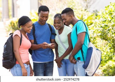 group of cute african american college students using cell phone on campus