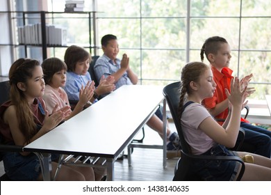 Group Cute Children  Student Clapping Hands Celebrating Together  In Classroom At School. Genius Kid Hand Up . Great Idea . Child Clever Sitting At Desk . Early Education
