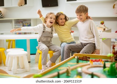 Group Of Cute Kindergarten Kid Friends Sitting And Having Fun