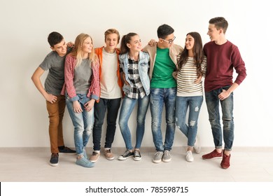 Group Of Cute Teenagers Near White Wall