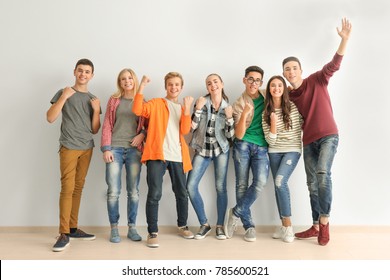 Group Of Cute Teenagers Standing Near White Wall