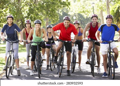 Group Of Cyclists On Cycle Ride Through Park