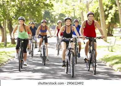 Group Of Cyclists On Cycle Ride Through Park