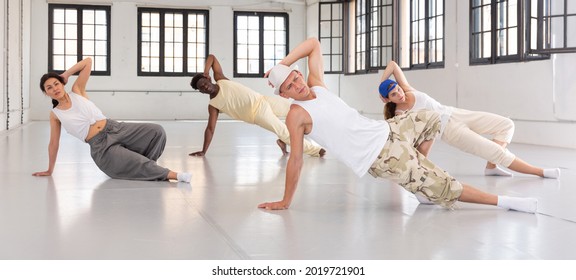 Group Of Dancers Training Modern Dance Moves In Ball Room