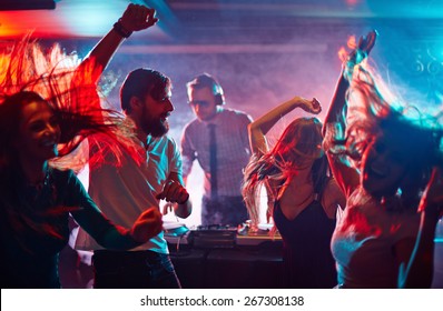 Group of dancing friends enjoying night party - Shutterstock ID 267308138