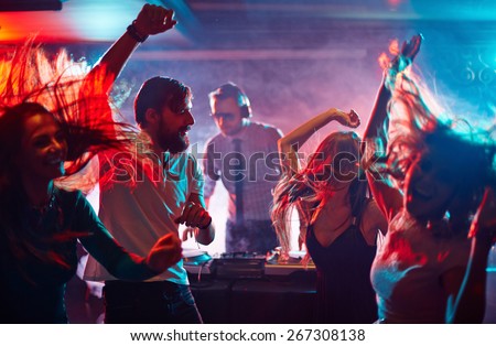 Group of dancing friends enjoying night party