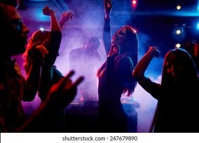 Group of dancing young people enjoying night in club - Shutterstock ID 247679890