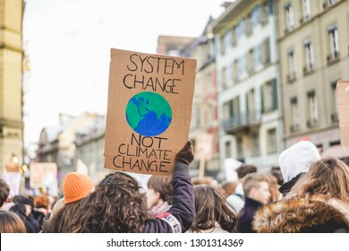 Group of demonstrators fight for climate change - Global warming and enviroment concept - Focus on banner - Shutterstock ID 1301314369