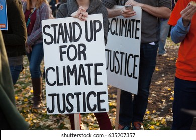 Group Of Demonstrators Hold A Sign Demanding Climate Justice