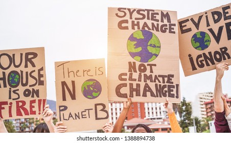 Group of demonstrators on road, young people from different culture and race fight for climate change - Global warming and enviroment concept - Focus on banners