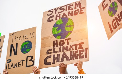 Group of demonstrators on road, young people from different culture and race fight for climate change - Global warming and enviroment concept - Focus on banners - Shutterstock ID 1493338499