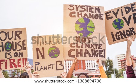 Group of demonstrators on road, young people from different culture and race fight for climate change - Global warming and enviroment concept - Focus on banners