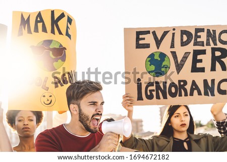 Group demonstrators protesting against plastic pollution and climate change - Multiracial people fighting on road holding banners on environments disasters - Global warming concept 