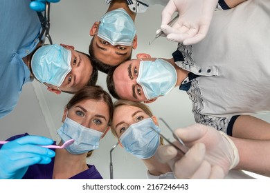 Group Of Dentists Holding Medical Instruments And Stant In A Circle At A Meeting. Patient Hospital