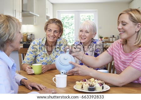 Group Of Different Aged Female Friends Meeting At Home