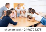 Group of different aged multiracial people attending foreign language course.