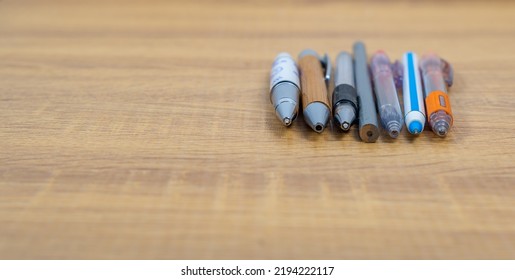 Group Of Different Pen On A Wooden Table, Copy Space, School And Equipment Concept, Soft Focus, Business In Different Way Concept.