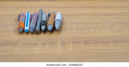 Group Of Different Pen And Pencil On A Wooden Table, Copy Space, School And Equipment Concept, Soft Focus, Business In Different Way Concept.