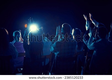 Group of of different people applauding, attending concert, stand up show, cheerfully spending time with jokes and funny stories. Concept of entertainment, fun and joy, concert, performance