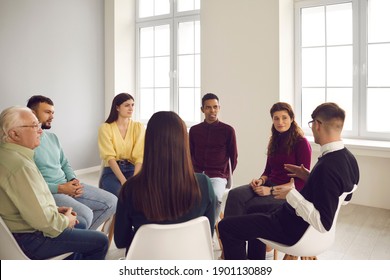 Group Of Different People Sit In A Circle And Each Talks About Their Problems During A Therapy Session At The Rehabilitation Center. Concept Of Help With Alcohol And Drug Addiction.