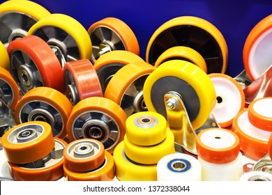 Group of different size and diameter industrial small wheels in warm yellow and orange colors for sale. Heavy Duty Fixed Polyurethane Industrial trolley Swivel Rubber Caster Wheels.
