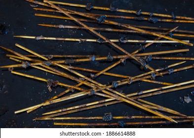 Group Of Dirty Bamboo Skewers With Leftover Food. Angled View Of The Used Wooden Skewers From Above. Selective Focus, No People.