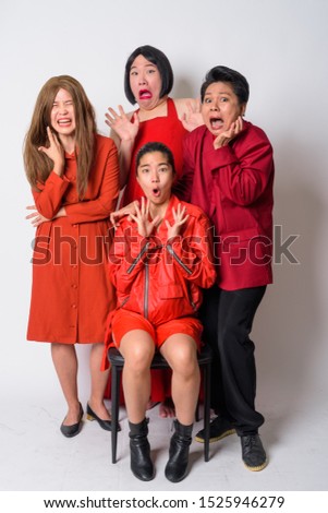 Group of diverse Asian friends looking shocked and scared together